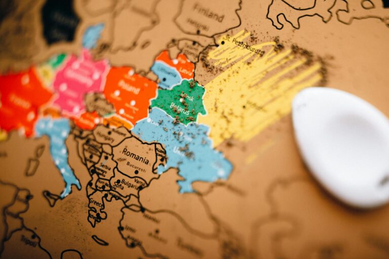 Close-up of a colorful scratch-off world map showing Europe with focus on planning travel.