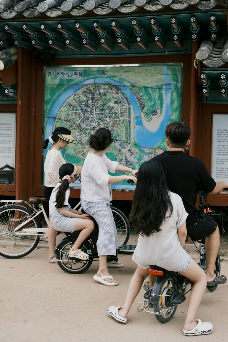 Family studying a map in Andong, South Korea while enjoying a cycling tour together.